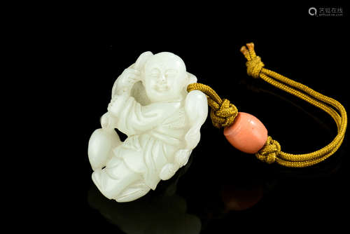 A CHINESE CARVED JADE ORNAMENT OF A BOY