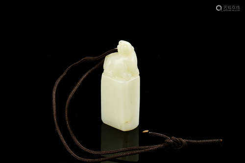 A CELADON JADE CARVED STAMP SEAL WITH STRING