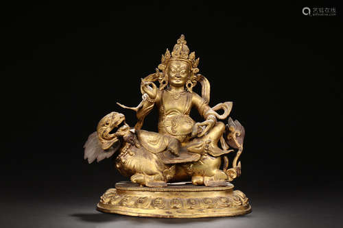 GILT BRONZE CAST BUDDHA RIDING ON MYTHICAL BEAST