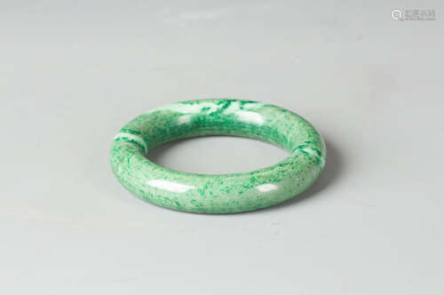 A LARGE CHINESE GREEN JADE BANGLE