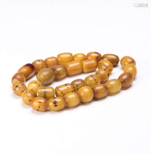 A STRAND OF BEESWAX BEADS, 30 BEADS