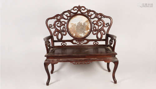 A ROSEWOOD ARMCHAIR WITH INTERWINED CARVING