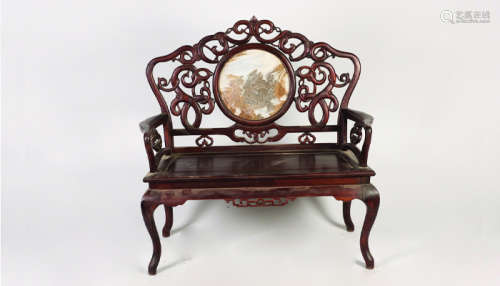 A ROSEWOOD ARMCHAIR WITH INTERWINED CARVING
