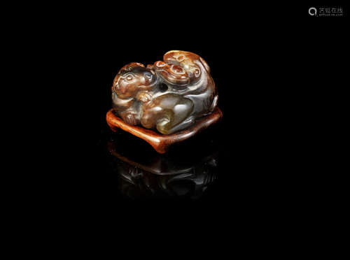 A reddish brown jade carving of two dogs,Probably Ming Dynasty