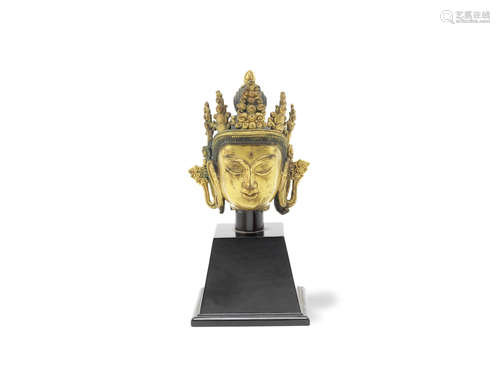 A gilt-bronze head of Buddhist deity