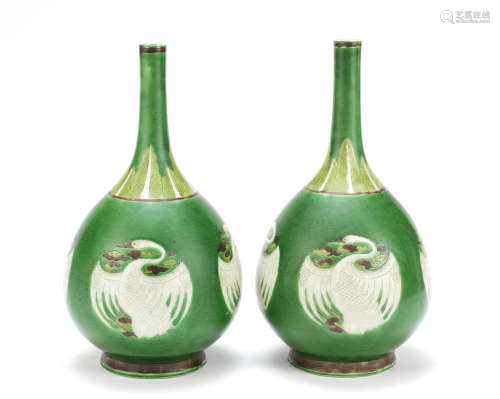 A pair of famille verte biscuit 'cranes' bottle vases,Late 19th century