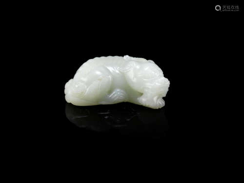 A white jade carving of a horned mythical beast
