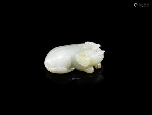 A pale green jade archaistic carving of a mythical beast