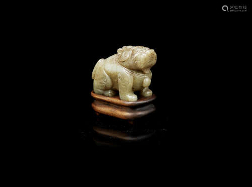 A pale green and russet jade carving of a seated luduan,Ming Dynasty