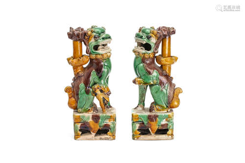 清康熙   三彩佛狮香托一对                                                                                                                                         A PAIR OF CHINESE EGG AND SPINACH GLAZED BISCUIT BUDDHIST LION DOG JOSS STICK HOLDERS.