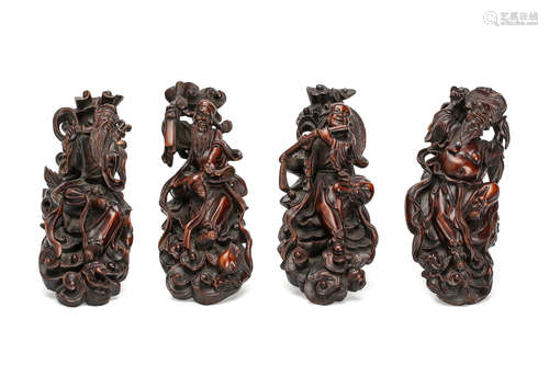 20世纪   红木仙人雕四件                                                                                                                                            A SET OF FOUR CHINESE WOOD CARVINGS OF IMMORTALS.