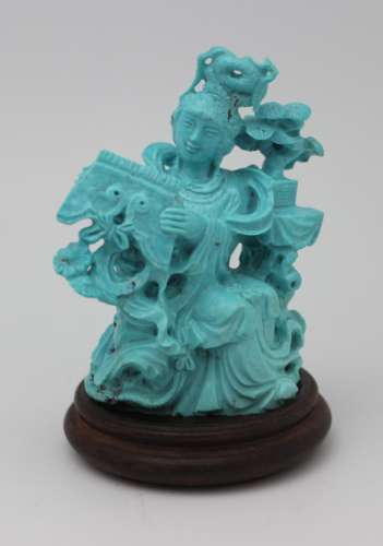 TURQUOISE CARVED SCULPTURE WITH WOOD BASE