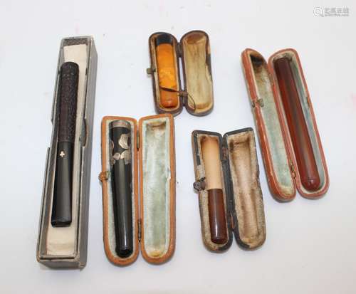 GROUP OF 5 AMBER AND BAKELITE CIGARETTE HOLDERS