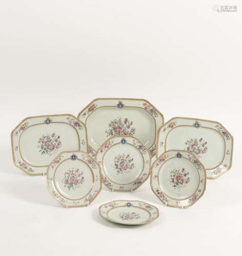 A CHINESE EXPORT PART FAMILLE ROSE ARMORIAL PORCELAIN DINNER SERVICE, painted with flowers within gilt borders,