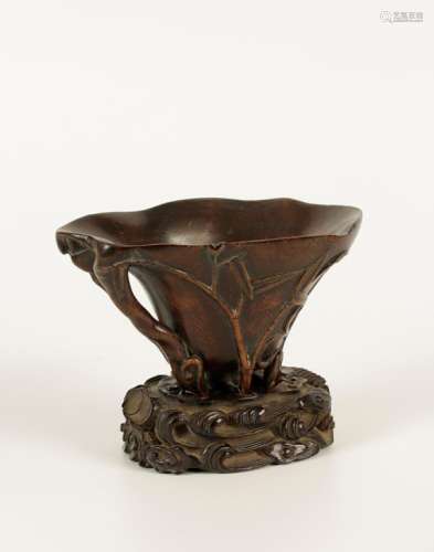 A CHINESE CARVED AND STAINED BAMBOO LIBATION CUP