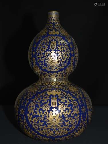 A COBALT BLUE GLAZED GILT GOURD VASER