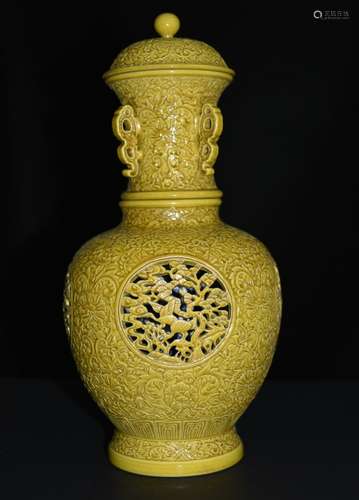 A YELLOW GLAZED CARVED REVOLVING VASE