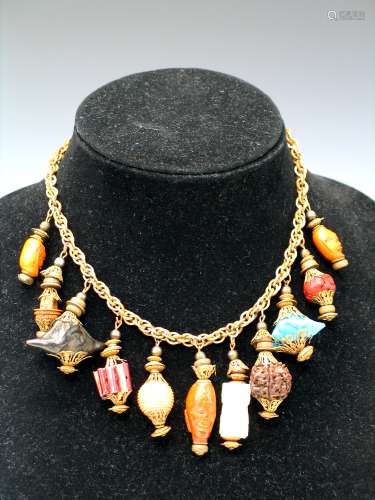 Metal necklace with carved nuts pendants.
