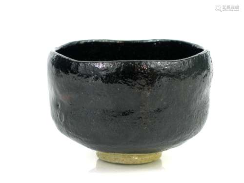 Japanese stoneware teacup with black glaze.