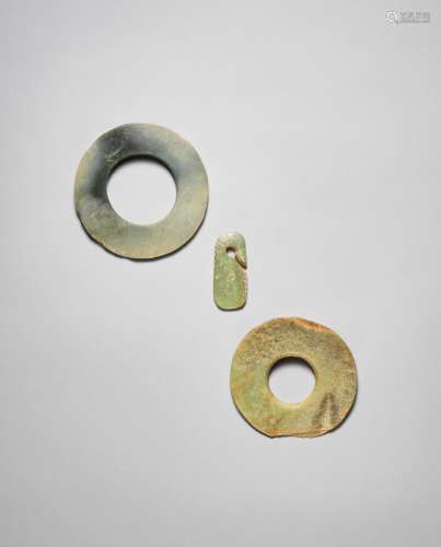 Two jade discs, bi, and an ear ornament