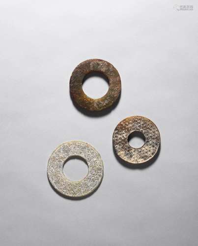 Two jade discs, bi; and a jade ring, huan