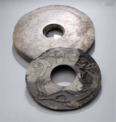 TWO CARVED JADE BI DISKS, China, Ming dynasty or eralier-Provenance: Collection Adalbert Colsman (1886-1978) by descent to the present owner-Partly chipped