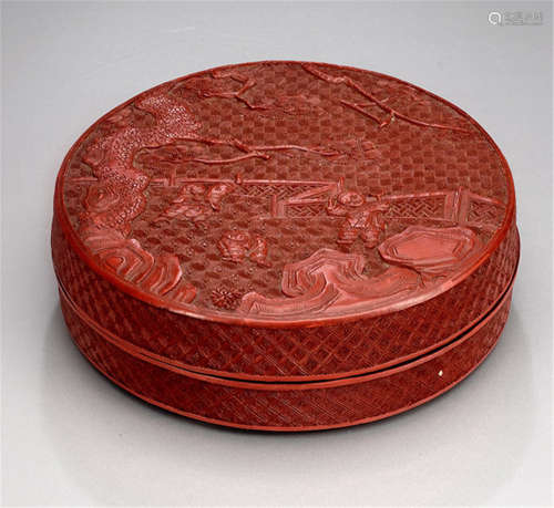 A CIRCULAR RED LACQUER BOX WITH A CARVED SCENE OF PLAYING BOYS
