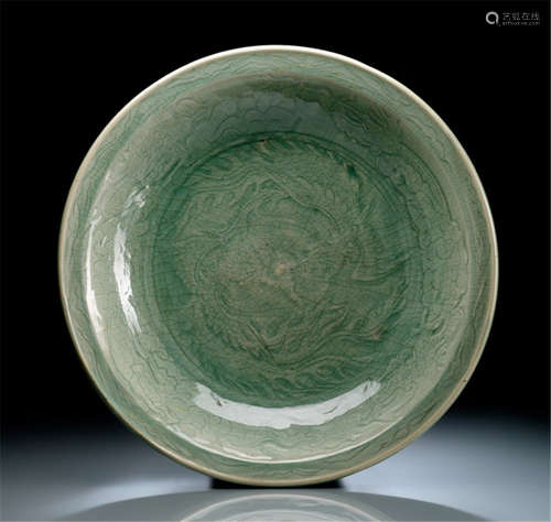 A LARGE CELADON PLATE WITH ENGRAVED AND INCISED DRAGON-PHOENIX DECORATION, China, Ming dynasty-Property from an important German private collection, by repute former property from the 'David and Peggy Rockefeller collection', acquired from Ralph M