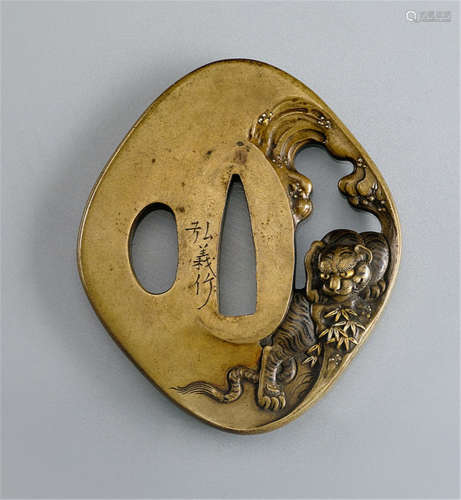 A SENTOKU TSUBA, Japan, signed Hiroyoshi saku, Meiji period, pierced and decorated with a tiger perched on a tree trunk with gilt details - Minor wear