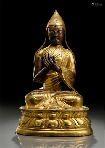 A PARCEL GILT-COPPER EMBOSSED FIGURE OF A LAMA, TIBET, late 18th ct