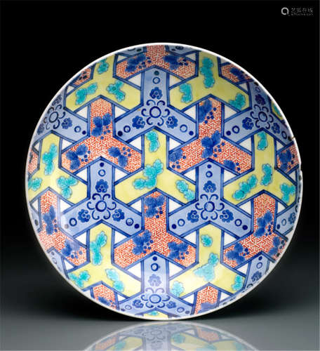 AN EXCELLENT NABESHIMA PORCELAIN DISH, Japan, 1690-1760, decorated  with 'yûsoku mon' in underglaze blue and polychrome enamels. The outside rim with three underglaze blue peonies surrounded with foliage. For a similar dish from the Tanakamura collection in Fukuoka, refer to the exhibition catalogue: 'Porcelaine précieuse des Seigneurs de Nabeshima', Mitsukoshi, Paris 16.12.1997-14.02.1998, no. 35, p. 127 - Another example was published in the exhibition catalogue of the Museum in Kanagawa, Japan: 'Hakubutsukan und Asahi Shinbunsha', Yokohama-shi, 20.09.-15.11.1987, no. 101 - The third example belongs to the Baur Foundation, Geneva, Suisse - Property from an old French private collection, purchased from Piasa, Paris, 14.05.2013 - Small rest. at the rim and small chip