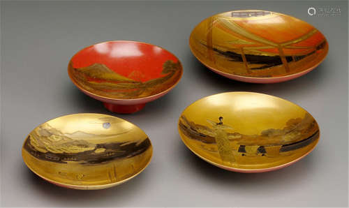 A GROUP OF FOUR VARIOUS LACQUER SAKE CUPS, Japan, two signed, Meiji period, decorated with famous sites, e.g. Mount Fuji - Property from an old German private collection, acquired before 1990 - Minor wear, two cups slightly chipped