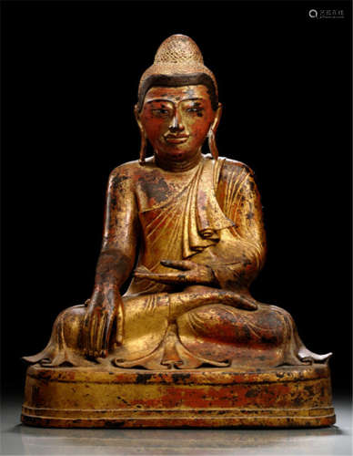 A GILT- AND RED-LACQUERED BRONZE FIGURE OF BUDDHA SHAKYAMUNI, Burma, Mandalay period, 19th Ct., seated in vajrasana on a pedestal with his right hand in bhumisparshamudra while the left rests on his lap, wearing samghati, his face displaying a serene expression with mother-of-pearl inlaid eyes, curled hair and ushnisha - Property from a French private collection - Partly minor traces of age