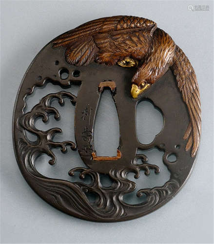 A SHAKUDO TSUBA, Japan, signed Toshinaga and kaô, pierced and partly decorated in relief, depicting an eagle above surging waves, details in copper and gilt - Minor wear