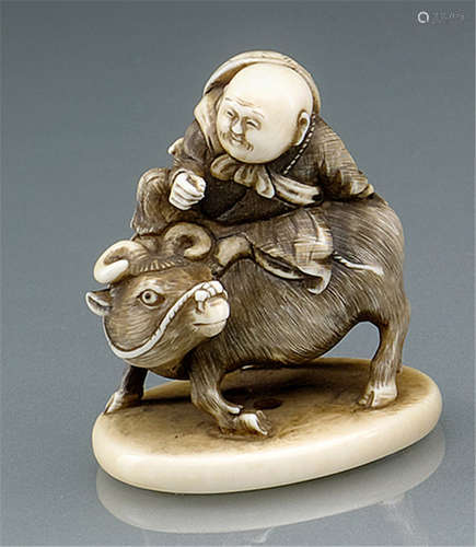 AN IVORY NETSUKE OF A HERD BOY ATOP AN OX, Japan, signed  ...sai, Meiji period  - Former property from an old Berlin private collection - Minor wear, right hand of herd boy replaced