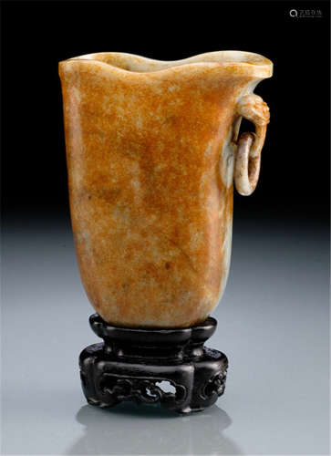 A GREY AND RUST-COLOURED JADE RHYTON, PARTLY TRANSLUCENT, WITH WOOD STAND China, Qing dynasty-Property from a French private collection, former property from the collection of Paul Louis Weiller (1893-1993), acquired at Gros & Delettrez, 5th Apr 2011-Two very short hairline cracks