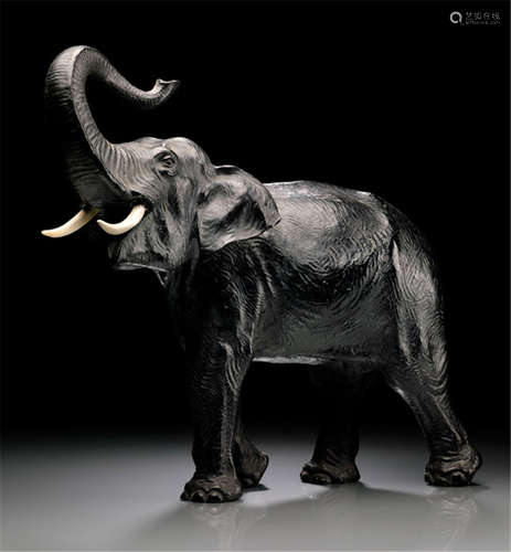 A BRONZE MODEL OF AN ELEPHANT, Japan, Meiji period, cast in standing posture with raised trunk, inserted ivory tusks - Formerly property from the Victor von Thurn and Taxis collection, in family possession since at least 1980 - Minor wear, trunk repaired, one tusk later made of synthetic material, partly small drill holes