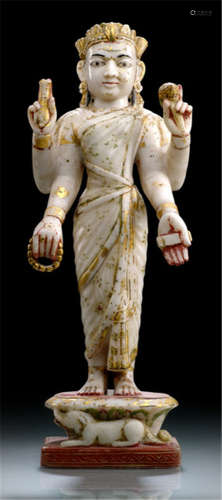 AN ALABASTER FIGURE OF PARVATI, North-India, 19th Ct., standing on a shaped base with her lion vehicle to the front, her four hands holding different attributes, wearing sari, her face with almond-shaped eyes and her head topped with a crown, traces of gilding and pigments - Property from an old Bavarian private collection, acquired between 1960 and 1990