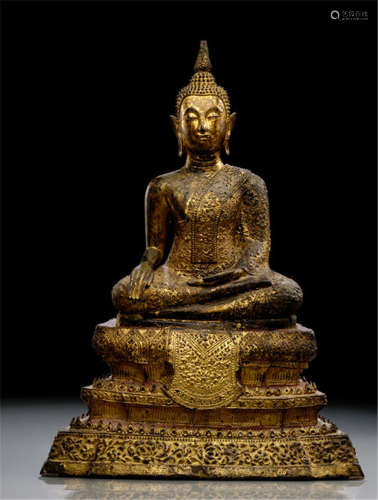 A GILT-, RED- AND BLACK-LACQUERED BRONZE FIGURE OF BUDDHA SHAKYAMUNI, Thailand, Rattanakosin period, late 18th Ct., seated in virasana on a cushion placed on a shaped throne with his right hand in bhumisparshamudra while the left rests on his lap, wearing samghatia, his face displays a serene expression with downcast eyes below arched eyebrows, his curled hair and ushnisha topped with a flame - Property from a German private collection, collected between 1966 and 2004 - Minor wear, slightly chipped