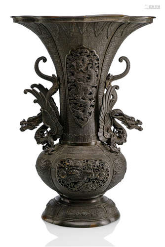 A BRONZE VASE, Japan, cast mark: Dai Nihon Bunsei nensei ...shu, Meiji period, the front and back of the neck with pierced decoration of dragons above medallions containing Shishi. Both handles in the shape of winged dragons - Property from an old Belgian private collection, acquired before 1990 - Minor wear