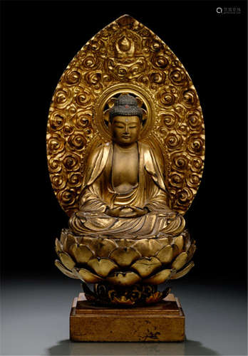 A GILT- AND BLACK-LACQUERED WOOD FIGURE OF BUDDHA AMIDA, Japan, Meiji period, seated in vajrasana with his hands resting on his lap in dhyanamudra, wearing a monastic garment, his face displaying a serene expression with downcast eyes below arched eyebrows running into his nose-bridge, urna, faint smiling lips, elongated earlobes and his curled hair rising into a low ushnisha - Property from a German private collection, collected between the 1980s and 1990s - Some wear, slightly chipped, partly age cracks and restuck