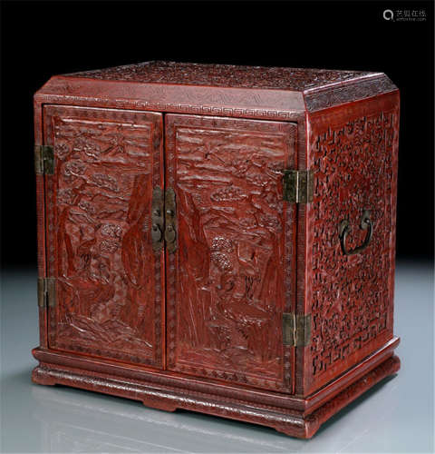 A CARVED AND MOLDED LACQUER CABINET WITH INCISED DECORATION