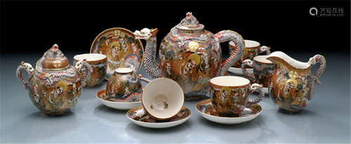 A SATSUMA TEA SET FOR SIX PEOPLE, Japan, marked Dai Nihon Satsuma-kuni Daimyô, Meiji period, decorated with figural scenes of Rakan and Sennin with Shimazu crests, dragon-shaped handles and spouts - Minor wear, fitted wood box