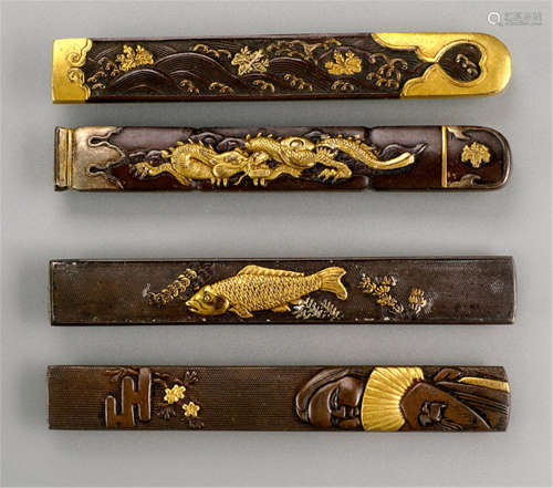 FOUR VARIOUS SHAKUDO KOZUKA, Japan, Meiji period, one decorated with Okame holding a fan, one with a swirrling dragon, one with a carp and one with kiri blossoms amidst waves, all with gilt details - Property from an old German private collection, assembled in the 1970s till 1988 - Minor wear