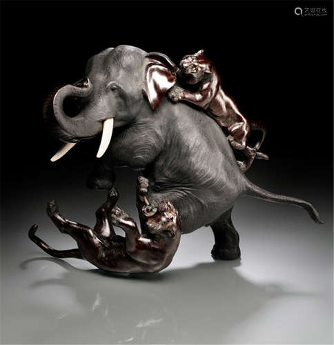 A BRONZE ELEPHANT AND TIGER GROUP, Japan, cast mark: Ômori Mitsumoto (Kôgen), Meiji period, the large elephant with twin ivory tusks, its trunk raised in distress as two tigers attack - German family property, acquired between 1960 and 1990 - Partly minor wear