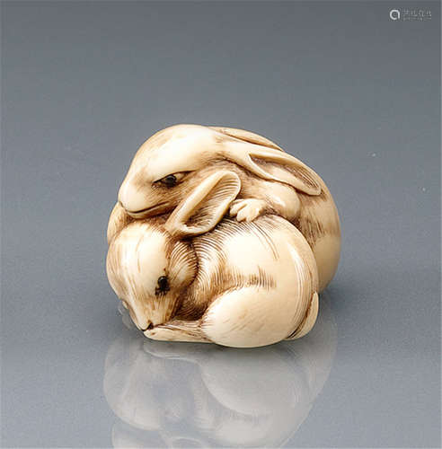 AN IVORY NETSUKE OF A PAIR OF SEATED HARES, Japan, 19th Ct. - Provenance: Formerly part of an old Berlin private collection - Minor wear