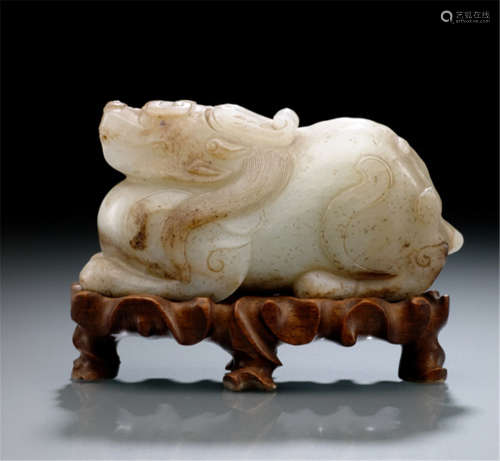 A FINE CAVED JADE MODEL OF A RECUMBENT ANIMAL, China, Ming/early Qing dynasty, carved wood stand-Provenance: Collection Adalbert Colsman (1886-1978) by descent to the present owner-Very tiny chips