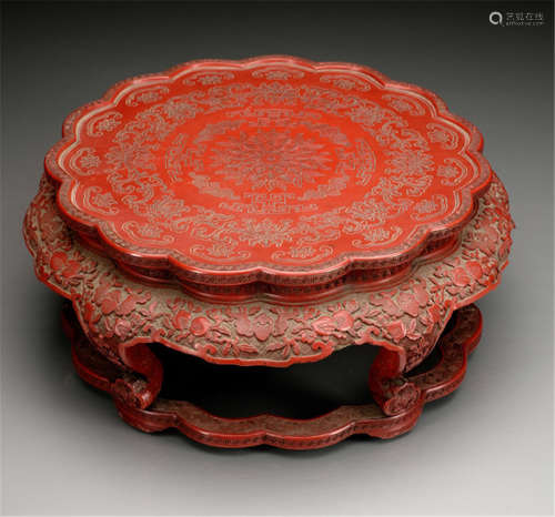 A LOBED RED CINNABAR LACQUER STAND WITH CARVED FLOWER AND BAT DECOR