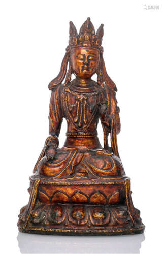A LACQUERED BRONZE FIGURE OF GUANYIN, CHINA, Ming dynasty, seated in vajrasana on a lotus base, both hands showing different gestures, wearing dhoti, bejewelled and his face displaying a serene expression-Property from a German private collection, since 1975 in the posession of the family of the current owner-Very slightly chipped, wear