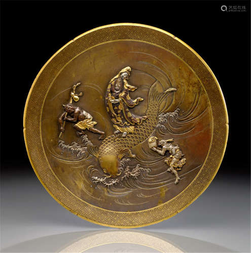 AN ELABORATE BRONZE DISH, Japan, signed: Ikôdô (Miyabe Atsuyoshi), Meiji period, the central roundel decorated with Gyoran Kannon standing on a carp leaping out of breaking waves, at each side a demon. Details accentuated in gold and silver - Property from a European private collection - Partly traces of use